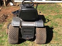 Rear view showing large rear tires, seat frame and Craftsman decal on fender