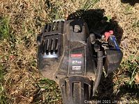 Close-up of the 27cc Craftsman string trimmer showing Speed Start engine labeled on the black casing.