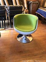Front view showing lime green leatherette seat, white shell and chrome pedestal base