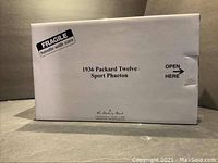 White Danbury Mint box labeled '1936 Packard Twelve Sport Phaeton' with fragile handling instructions.