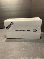 White cardboard Danbury Mint box labeled 'The 1927 Stutz Black Hawk' with 'Fragile - handle with care' sticker.