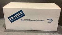 Side view of white cardboard box labeled 'The 1934 Hispano-Suiza J12' with fragile handling sticker.