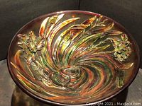 Top view of resin floral art bowl showing vibrant, multi-colored swirling pattern with floral shapes in raised relief.