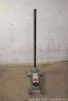 Top view of the 3-ton floor jack standing upright showing handle and main lifting body.