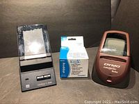 Front view of CoStar XL Turbo LabelWriter, DYMO LabelWriter Turbo, and two rolls of shipping labels