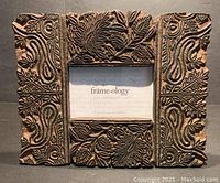 Front view of one Balinese-style horizontally orientated carved wood photo frame.