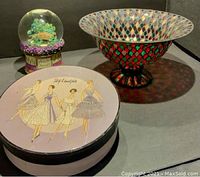 Lot showing the glass musical globe, colorful Tiffany-style bowl, and vintage Rosanna hatbox.