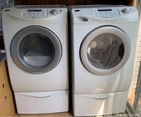 Washer and dryer on pedestals, front view