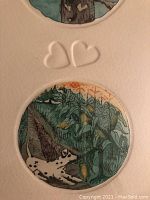 Close-up image of etching showing Dalmatian dog near green corn plants and embossing of two hearts on mat.
