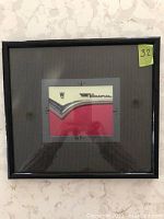 Framed photo of a Crown Victoria car door with black frame and double matting.