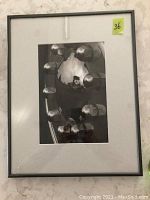 Full view of the framed black and white photo with white matting and a black frame, showing the reflective hubcap and antique car image.