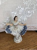 Porcelain ballerina figurine with detailed lace skirt and delicate hand-painted face and hair