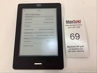 Front view of Kobo Touch EReader showing device information screen with software version, memory, and settings.