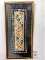 Full view of antique framed embroidered textile showing the artwork and frame.