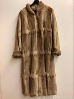 Full front view of vintage brown panel fur coat neutral background