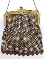 Front view of purse showing frame, chain handle and mesh pattern