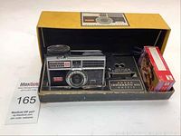 Full view of Kodak Instamatic 400 camera outfit in original box showing camera, flash cube holder, and film cartridge.