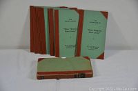 Photo showing seven vintage hardcover decorating books with green and brown covers arranged standing and lying flat.