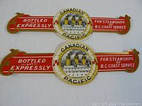 Photo of two vintage metal bottle neck labels with Canadian Pacific steamship image and text, red and gold colors.