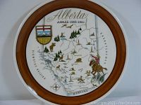 Front view of the large ceramic platter showing Alberta Jubilee 1905-1955 design with wooden rim.