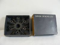 Candle holder inside its black original Dansk Designs Ltd box, top view showing item and box.