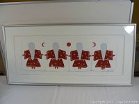 Full view of the framed indigenous painting showing four figures with red robes and white hair.