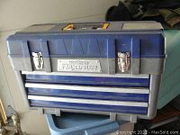 Closed blue Maxiforce Maximum plastic toolbox with metal latches and yellow handle