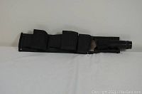 Black nylon sheath containing the knife, with visible multiple compartments and flaps