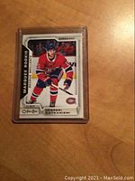Front image of the Jesperi Kotkaniemi 2018-19 O-Pee-Chee hockey rookie card in a protective case showing player's photo and card labeling.