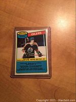 Front side of the 1980 O-Pee-Chee Wayne Gretzky hockey team leader card in protective plastic, showing Gretzky in Oilers uniform.