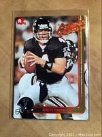 Front of 1991 Brett Favre rookie football card showing action shot of Favre in Falcons uniform.