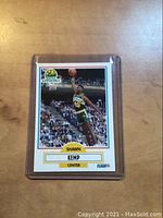 Front of Shawn Kemp rookie card showing player mid-action in Seattle SuperSonics uniform.
