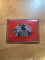 Front side of 2016 Goodwin Champions Michael Jordan Royal Red parallel basketball card showing red background with black and white image of Jordan and gold border.