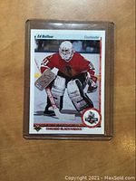 Front of 1990 Upper Deck Ed Belfour hockey rookie card showing player in goalie gear with Chicago Blackhawks.
