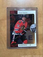 Front of 2015-16 Upper Deck SP Authentic Artemi Panarin hockey rookie card in protective sleeve showing player in Blackhawks uniform.