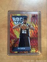 Front of 1998 Topps Rock Men Tim Duncan basketball card with fiery holographic design and player image.