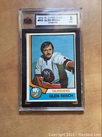 Photo of the front of the hockey card showing Glen Resch in Islanders uniform with KSA grade 5 label visible at top.