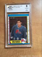 Front view of 1989-90 O-Pee-Chee #113 Joe Sakic card in BCCG plastic slab showing label grade and card artwork