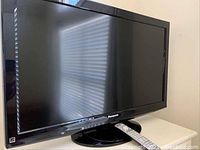 Front view of the Panasonic 37 inch flatscreen TV powered off, showing screen and base.