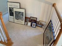 Two large Ansel Adams framed posters and a collection of assorted picture frames and pictures arranged near stairway