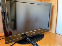 Front view showing full screen and remote on stand