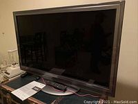Front view of Panasonic 42 inch television on swivel base showing screen and brand logo.