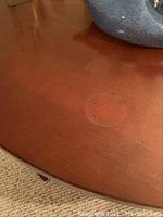 Close-up detail of table surface showing faint stain or ring mark