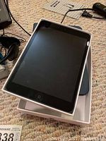 Apple iPad Mini model A1432 in black with Belkin protective case, shown in original box with screen visible