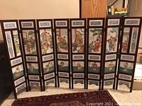 Full front view of the fully extended six-panel fireplace screen showing overall structure and tile design