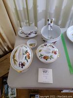 Overview of eight-piece set showing covered casseroles, gravy boat with plate, bowls, platter and utensil holder.