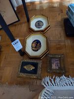 Photo showing two Limoges framed artworks and two small metal boxes on the floor, providing overall item visibility.