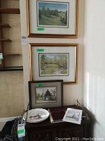 Two framed colored prints of St Thomas Golf And Country Club golf scenes by Peter Robson in gold-tone frames with mats, above a smaller framed print of Lynch Gate, Old Church, St Thomas.