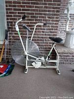 Full left-front view of white Schwinn AirDyne exercise bike showing fan wheel, frame, dual-action handlebars and seat