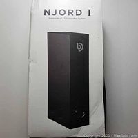 Box of NJORD I subwoofer showing branding and product image